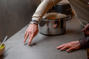 Cocina revestida con el modelo Piasentina Mud de ABKSTONE y sistema de inducción invisible Cooking Surface